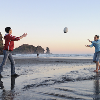 A wild New Zealand beach is a great place to toss a rugby ball around.