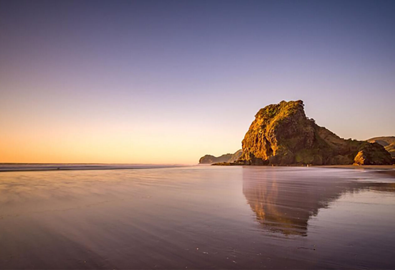 Piha is a scenic black-sand surf beach on the rugged coast west of Auckland. There are several walks through native forest in the surrounding hills.