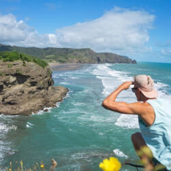 Watching the break at Bethells Beach on Auckland&#039;s west coast, just half hour drive from the city centre.