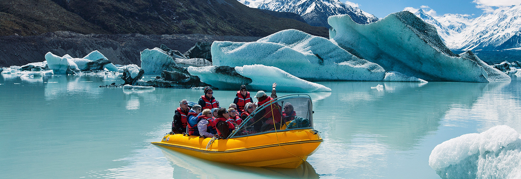 Glacier Explorers take visitors to see the Tasman Glacier and touch floating ice