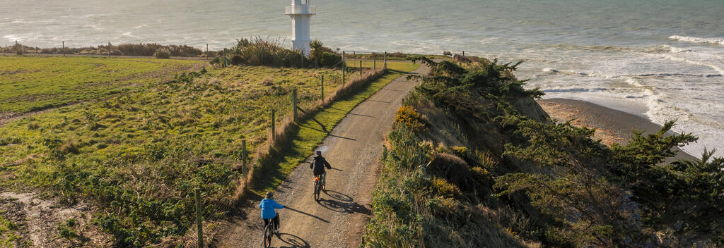 People riding bikes at Jack's Point Lighthouse, Timaru