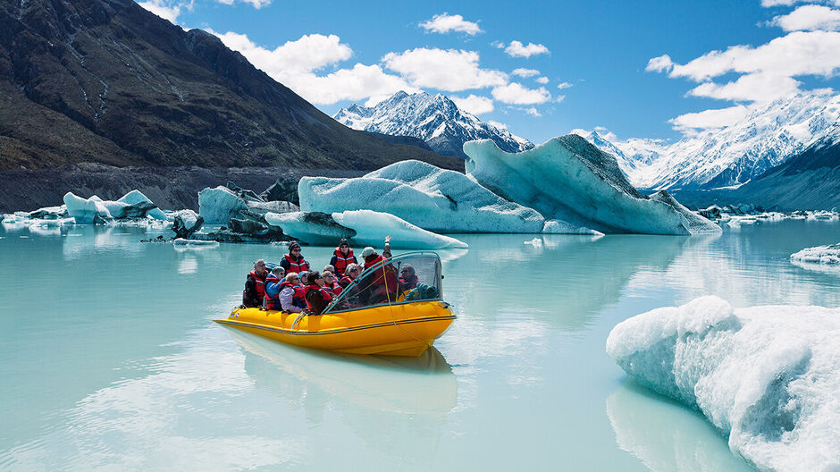 Glacier Explorers take visitors to see the Tasman Glacier and touch floating ice