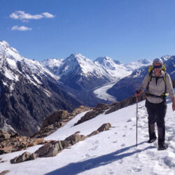 A trekker on Ball Ridge, above Caroline Hut.