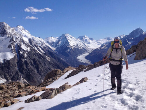 A trekker on Ball Ridge, above Caroline Hut.