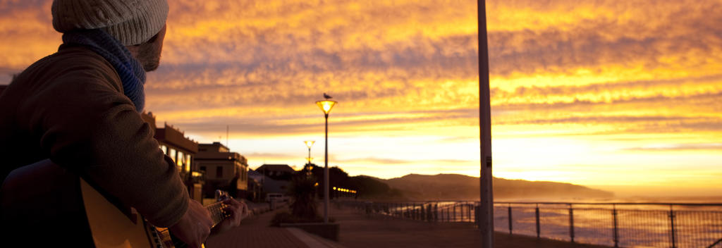 Find a spot on the waterfront at Saint Clair Beach in Dunedin and see if the New Year brings good surf on the first day.