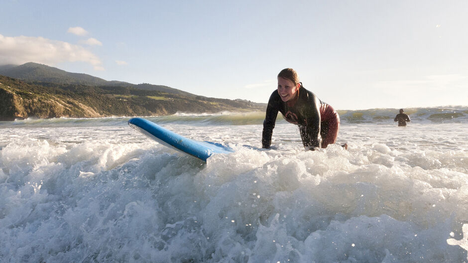 Learning to surf at Ngarunui Beach, Raglan