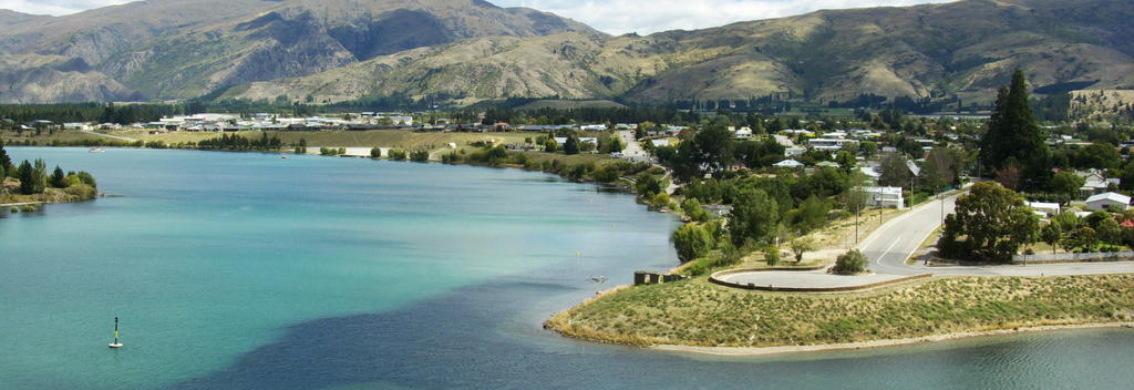 Cromwell stands on the shore of Lake Dunstan