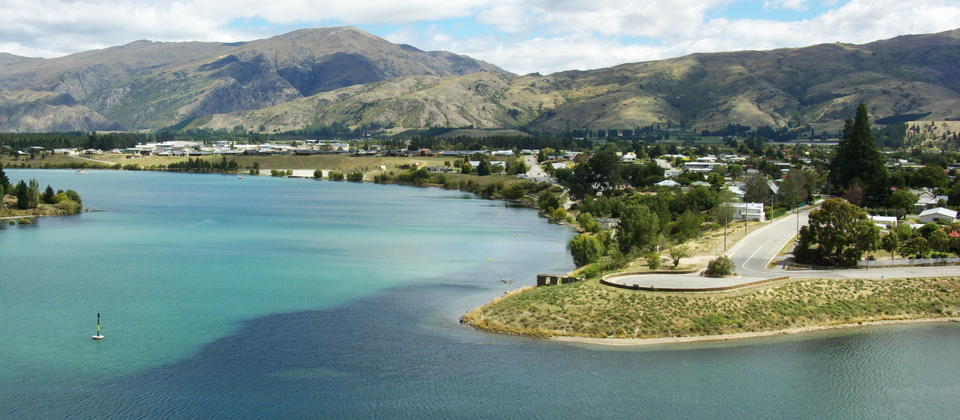 Cromwell stands on the shore of Lake Dunstan