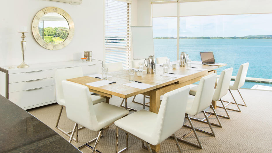 The 12-seater dining room table is the perfect setting for an intimate dinner or productive boardroom meeting.