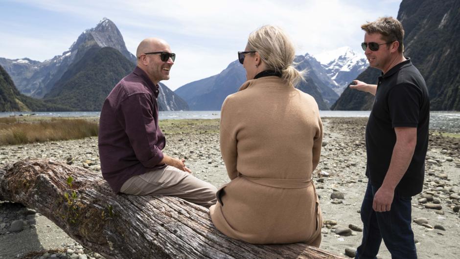 Couple listening to pilots storytelling in Milford Sound.
