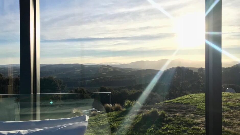 Watch the sunset over the rolling hills from the Atatū PurePod