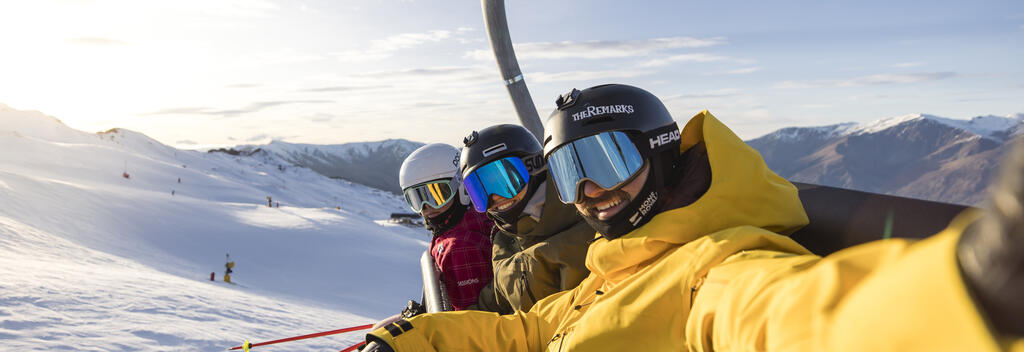 Skiers taking a selfie on the ski lift at Coronet Peak, Queenstown
