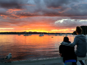 Couple watching the sunset in the Bay of Islands