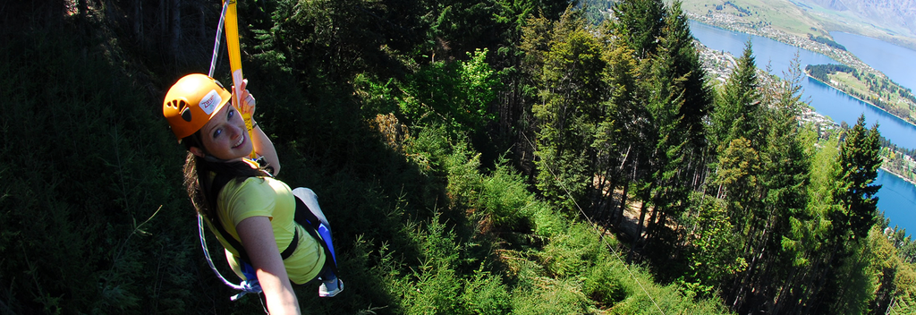Gaze across green forest and out to Lake Wakatipu when you zip line in Queenstown