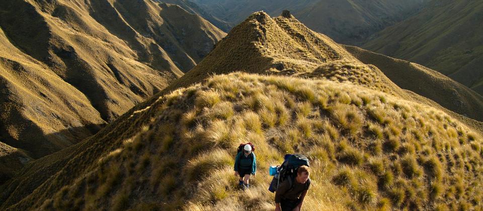 Along the trail, hikers trek through uninhabited wilderness on the Motatapu Alpine track