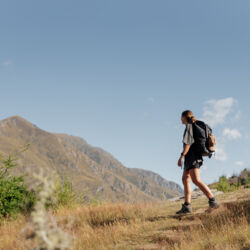 Woman hiking and admiring mountain views on the Queenstown Hill track 