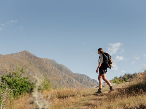 Woman hiking and admiring mountain views on the Queenstown Hill track 