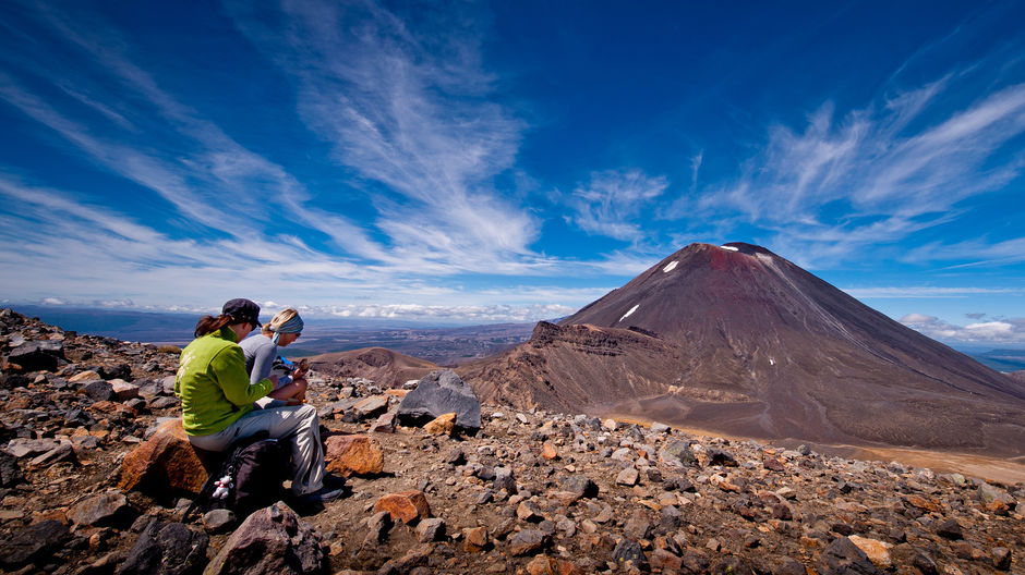 The plateau rest stop at the highest point of the Tongariro Alpine Crossing is a chance to grab a snack and take in the stunning scenery.
