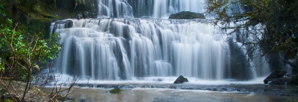 Marvel at the three-tiered waterfall in the Catlins