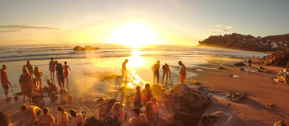 Its a community spa at sunrise on Hot Water Beach in The Coromandel.