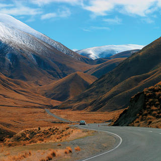 The Lindis Pass is memorable for its triangular hills clad in tussock grass.