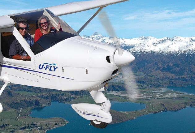 Snowy peaks tower over turquoise waterways and waterfalls cascade down rocky outcrops – a scenic flight in Wanaka is truly unforgettable.