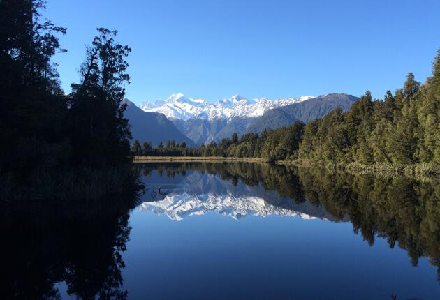 Wander through ancient forest and gaze on mirror-like reflections of New Zealand's highest mountain Aoraki/Mount Cook on this easy Lake Matheson hike.