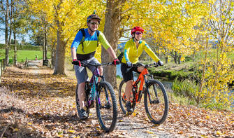 Couple cycling in Autumn, Hauraki Rail Trail,