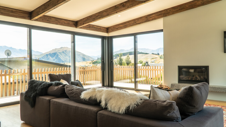 Release Wanaka - Farrant Drive. Open planned living area with gas fire.