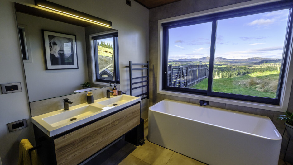 Morning light floods the elegant main bathroom with gorgeous easterly views, huge shower and a glorious deep bath.