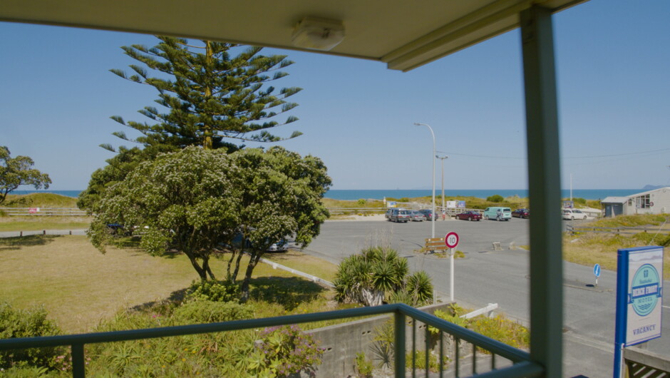 The view of Ruakaka Beach carpark and cafe across the road from the southside of the motel. Providing you with easy beach access.