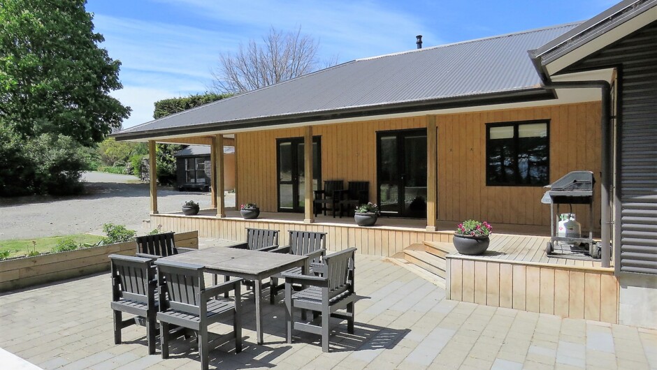 The BBQ and outdoor living area with ample room for dining and relaxing. A sandpit and a selection of sandpit toys are also available to keep younger children amused.