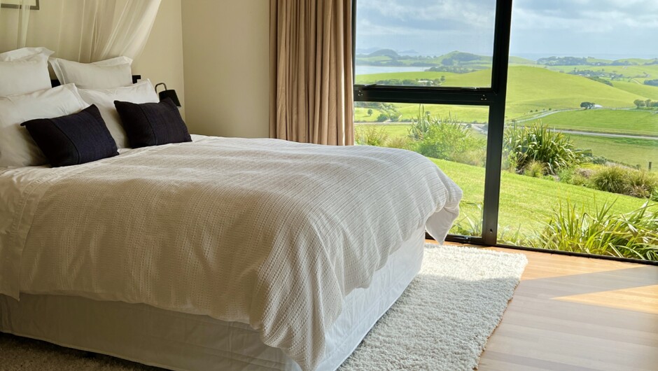 Master bedroom at Te Kahu. Walk-in wardrobe and private ensuite with shower and bath as well as a separate toilet.