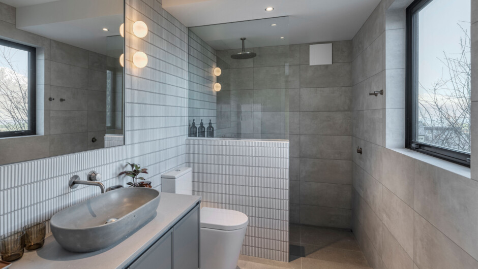 Matariki Residence has four bathrooms - two stunning private ensuites, and two larger shared bathrooms both containing baths. There's also a separate powder room on the upper level.