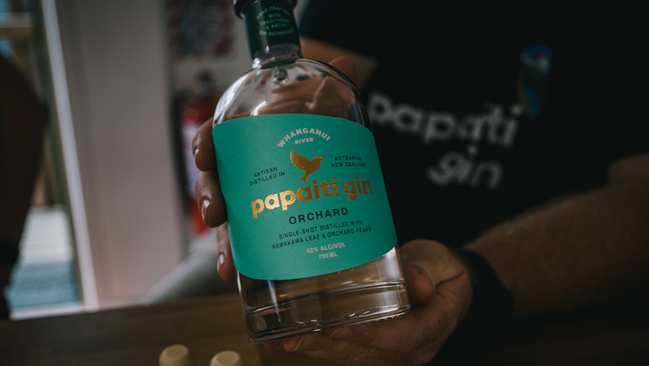Papaiti Gin Orchard bottled held by distiller Adrian.