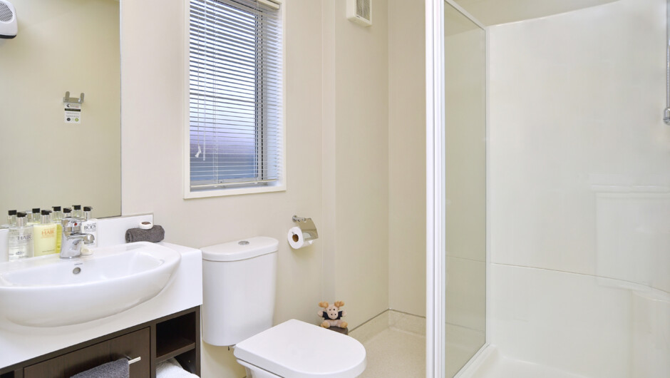 The ensuite bathroom in a studio room. All bathrooms have a toilet, vanity, shower, toiletries and towelling - three rooms also have spa baths.