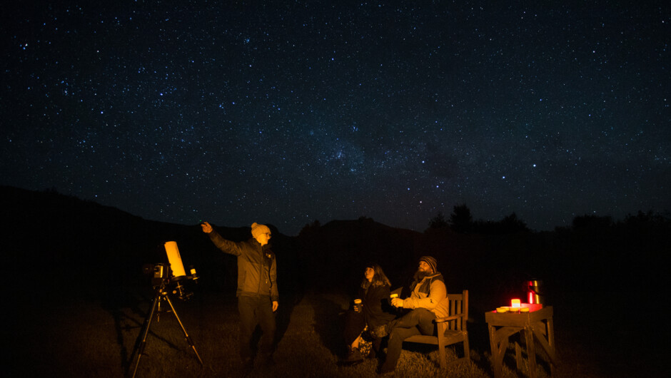 Embrace the night's wonder: guided stargazing under cozy blankets with steaming drinks, lost in celestial tales.