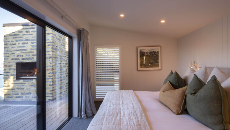Fernlea master bedroom with private ensuite and sliding door that opens up towards the lake and onto the veranda
