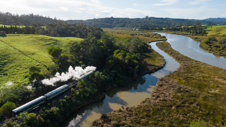 Gabriel our flagship Steam engine travelling alongside the beautiful Taumarere River.