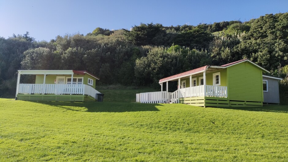 Left: Seaview (sleeps up to 5) using camp kitchen and toilet facilities Right: Mountainview (sleeps up to 8) self contained with kitchenette, shower & toilet.