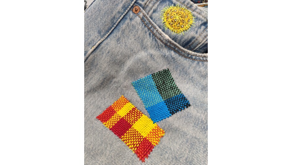 A students work repairing a hole in a pair of jeans at their Visible Mending with a Speedweve Darning Loom Workshop.