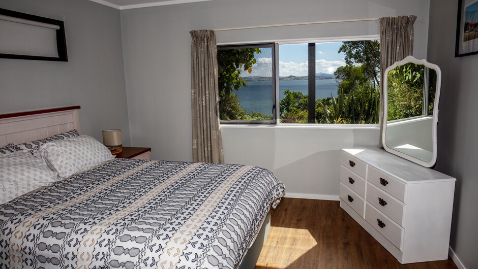 Queen bed in master bedroom with seaview