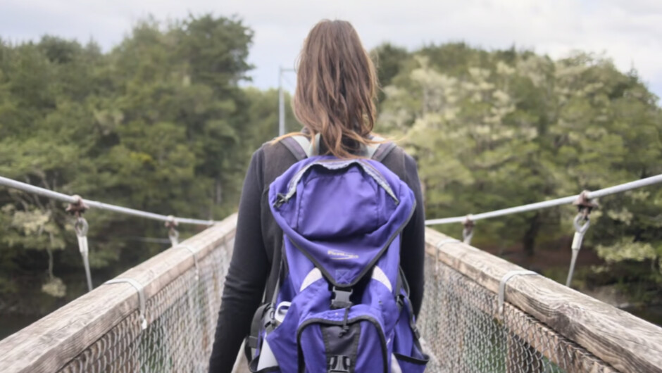 Crossing a swing bridge on the Kepler Track. Tracknet provides daily bus services and transport for Great Walks and day hikes from Te Anau.