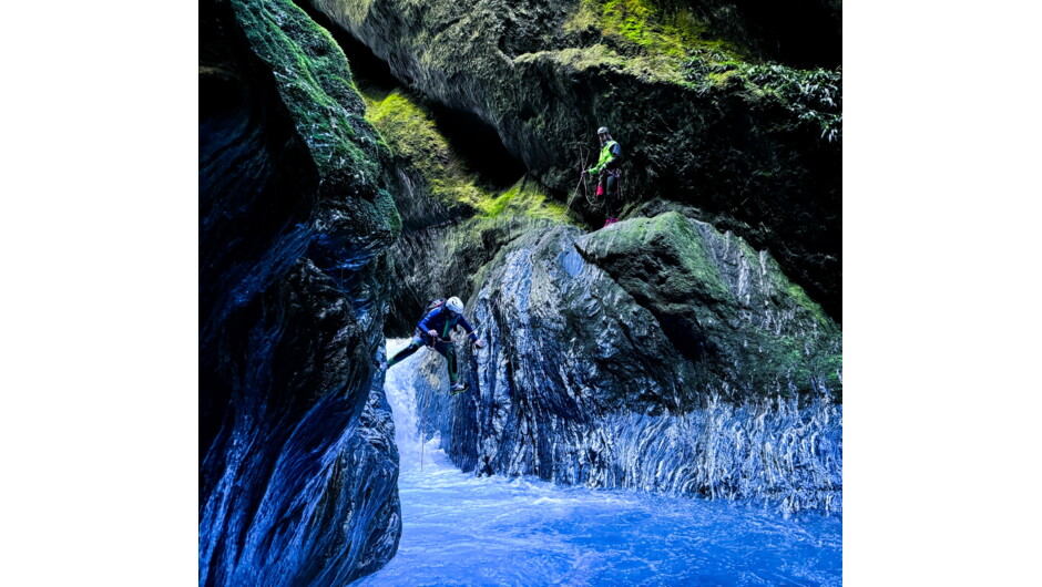 Two people traversing through the canyon