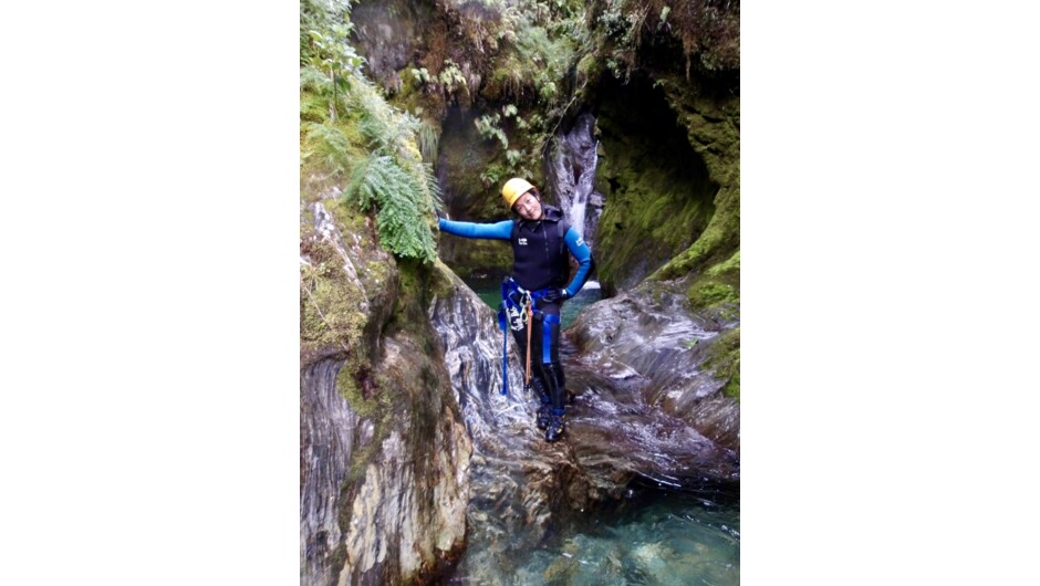 A person posing for a picture in the canyon