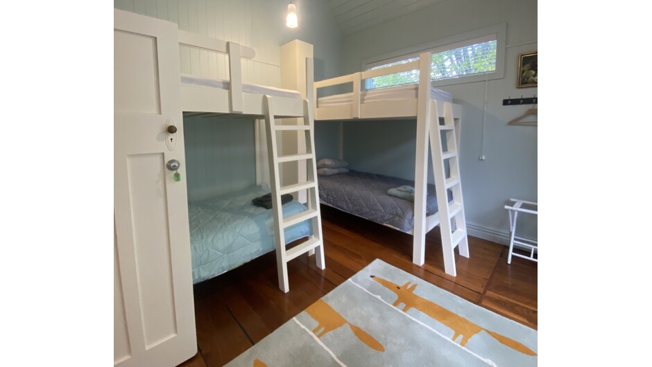 Schoolhouse Cottage - bunkroom 1 of 3. Four king single bunks with charging points, bedside light and lockable storage for valuables.
