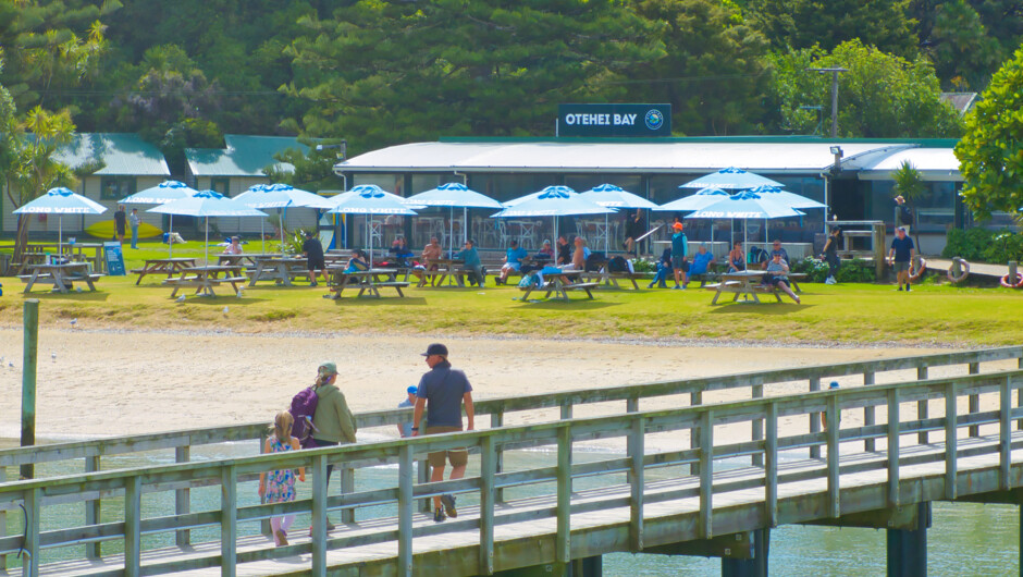 Passengers walking along Otehei Bay Wharf