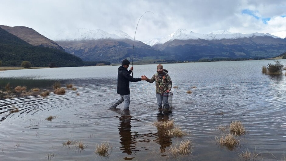 A high-five for a happy client fly fishing near Queenstown