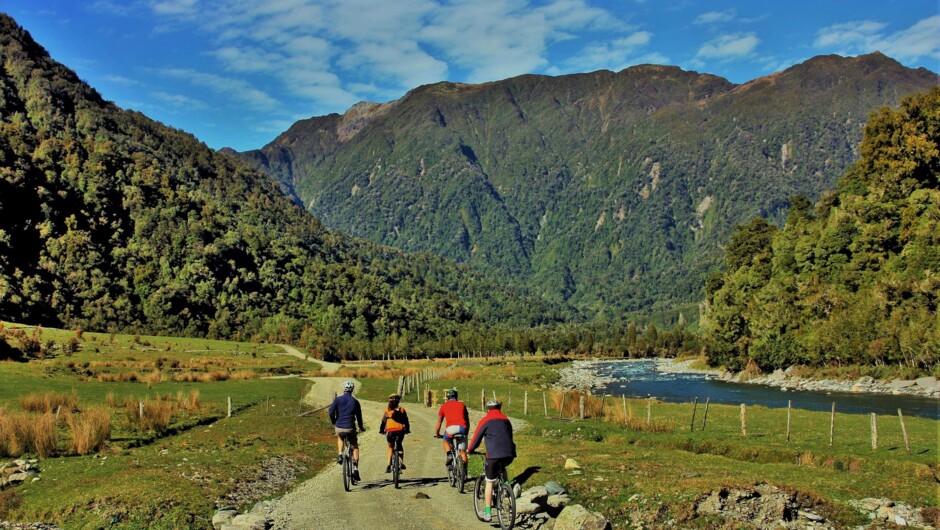 Biking along the Arahura River, West Coast Wilderness Trail