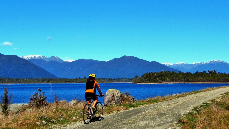 Cycling past Kapitea Reservoir, West Coast Wilderness Trail